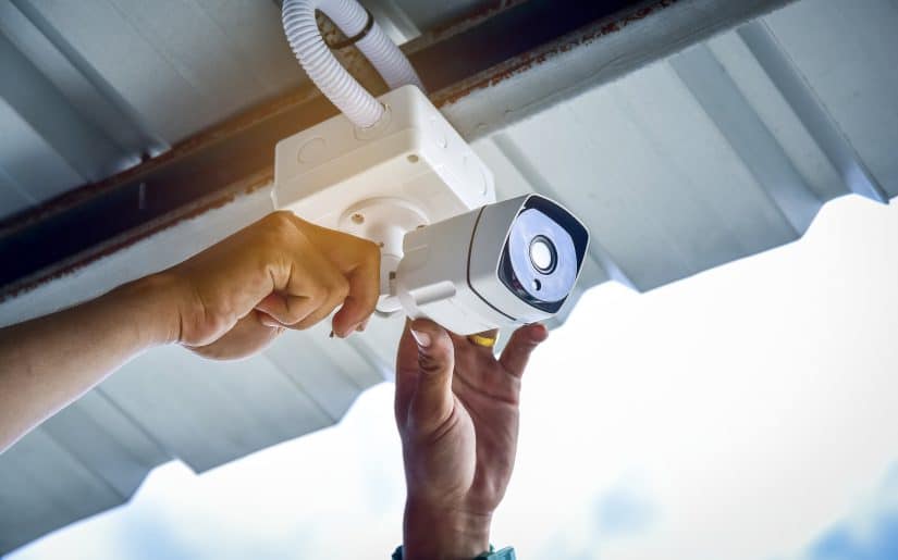 Person Installing Small Security Camera